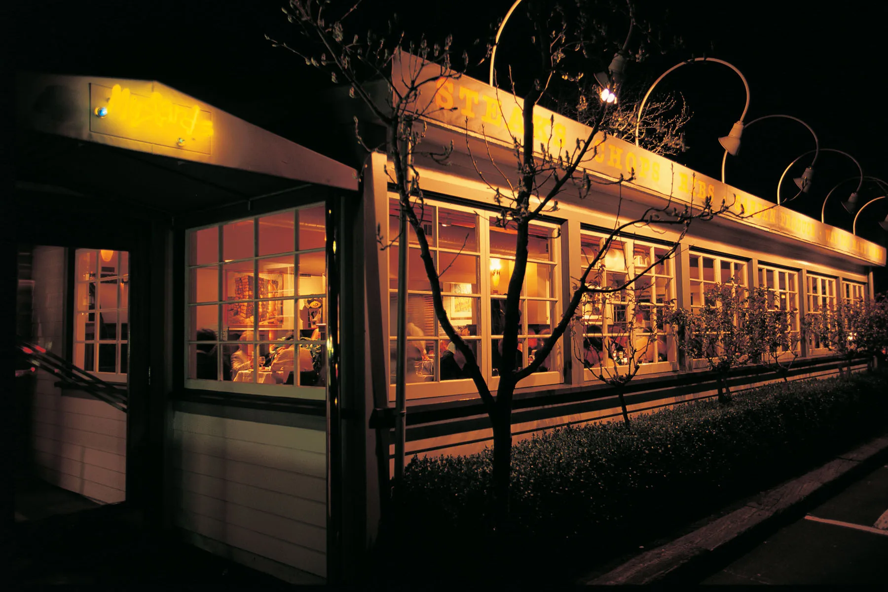 Mustards Grill exterior at night